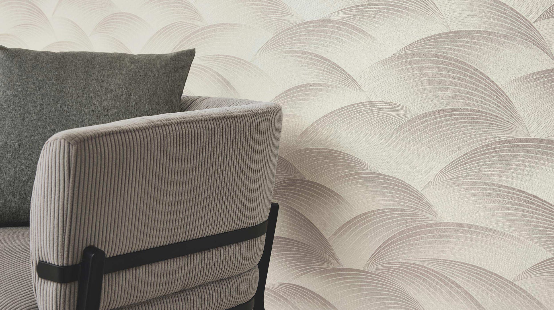 Erismann Fashion For Walls 4 10372-30 wallpaper feature wall in a modern lounge with soft wave pattern behind a ribbed upholstered armchair and cushion, calm minimalist mood.