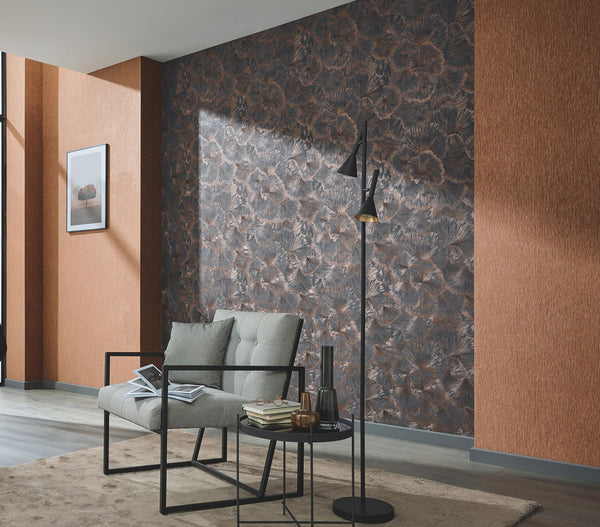 Erismann Fashion For Walls 4 10373-47 wallpaper modern lounge feature wall with dark floral pattern, textured side walls, tufted armchair with black frame, round side table with books and vases, floor lamp, framed art, and a calm contemporary mood.