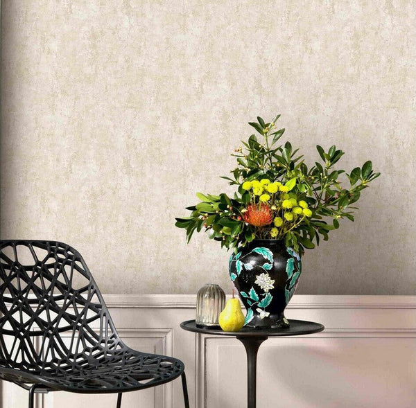 Erismann Fashion For Walls 4 10375-02 wallpaper lounge feature wall with paneling, modern black chair, and a round side table holding a floral vase, glass cloche, and pear for a relaxed, styled look.