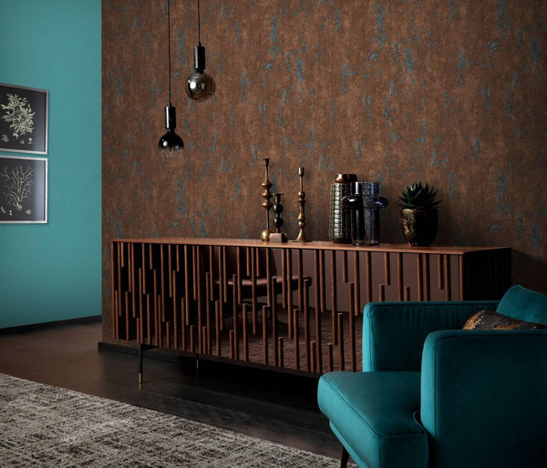 Erismann Fashion For Walls 4 10375-19 wallpaper lounge feature wall with textured brown finish, wooden sideboard styled with vases and candlesticks, teal armchair, and pendant lights for a moody modern look.
