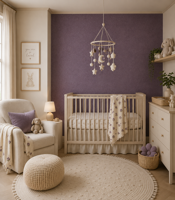 Erismann Fashion For Walls 4 10377-45 wallpaper cozy nursery with a purple feature wall behind a wooden crib, armchair with side table and lamp, mobile, dresser and woven accents, calm and softly lit.