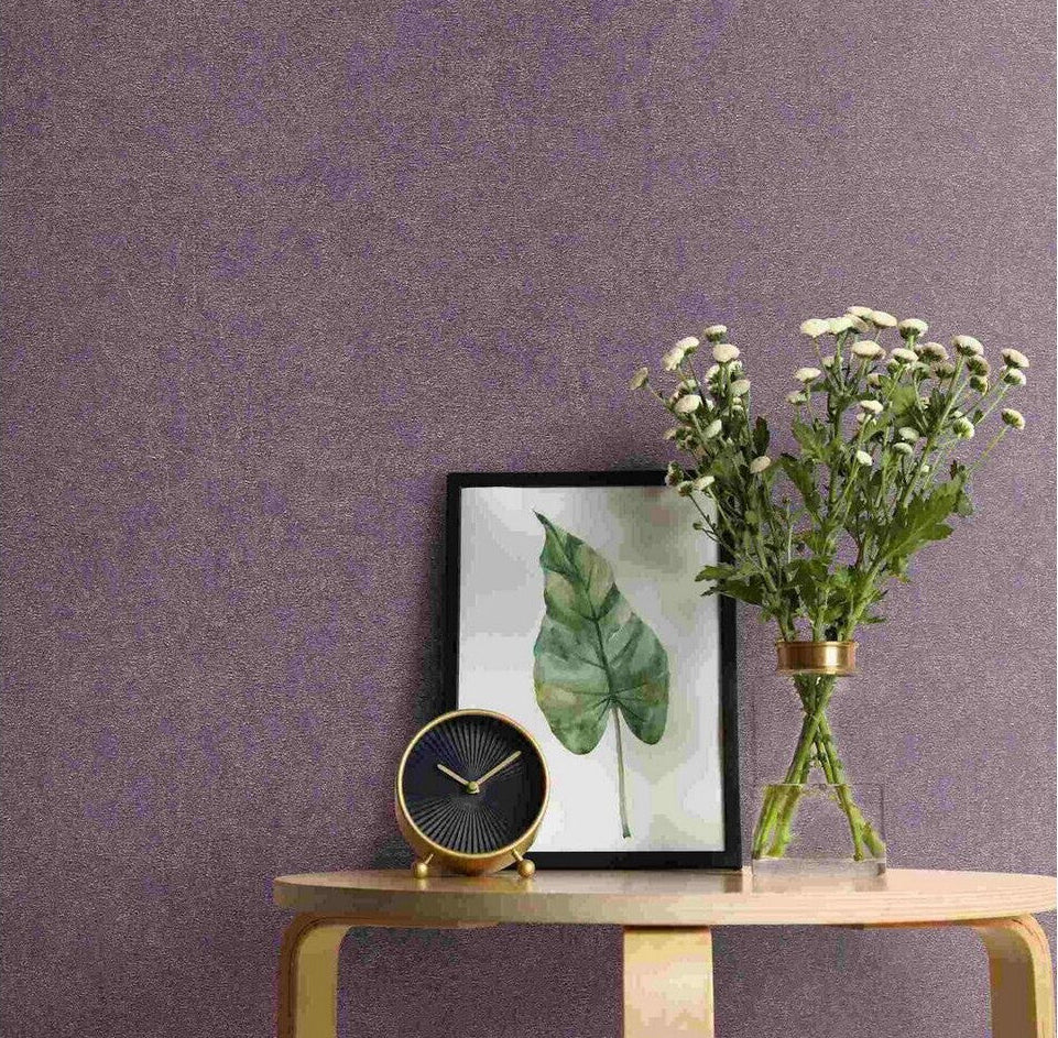 Erismann Fashion For Walls 4 10377-45 wallpaper in a lounge feature wall behind a light wood console table with framed leaf print, round clock, and glass vase of white flowers, relaxed modern feel.