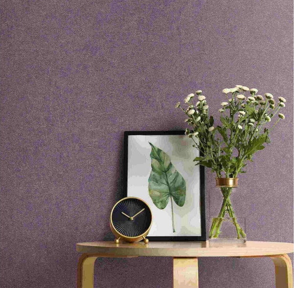 Erismann Fashion For Walls 4 10377-45 wallpaper in a lounge feature wall behind a light wood console table with framed leaf print, round clock, and glass vase of white flowers, relaxed modern feel.
