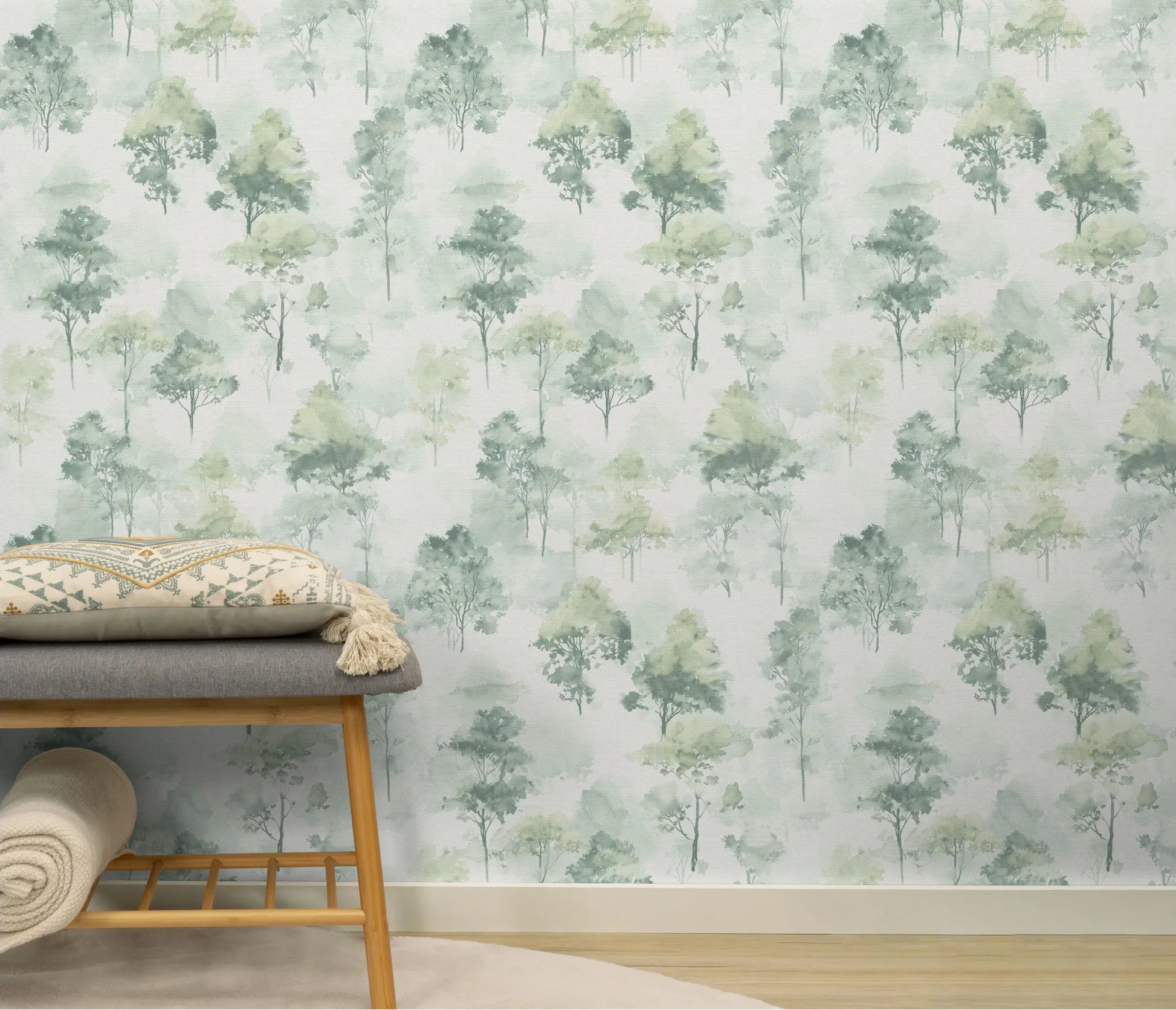 Erismann Forest Dreams 10557-07 wallpaper with misty watercolor tree pattern behind a bench with patterned cushion and folded throw.