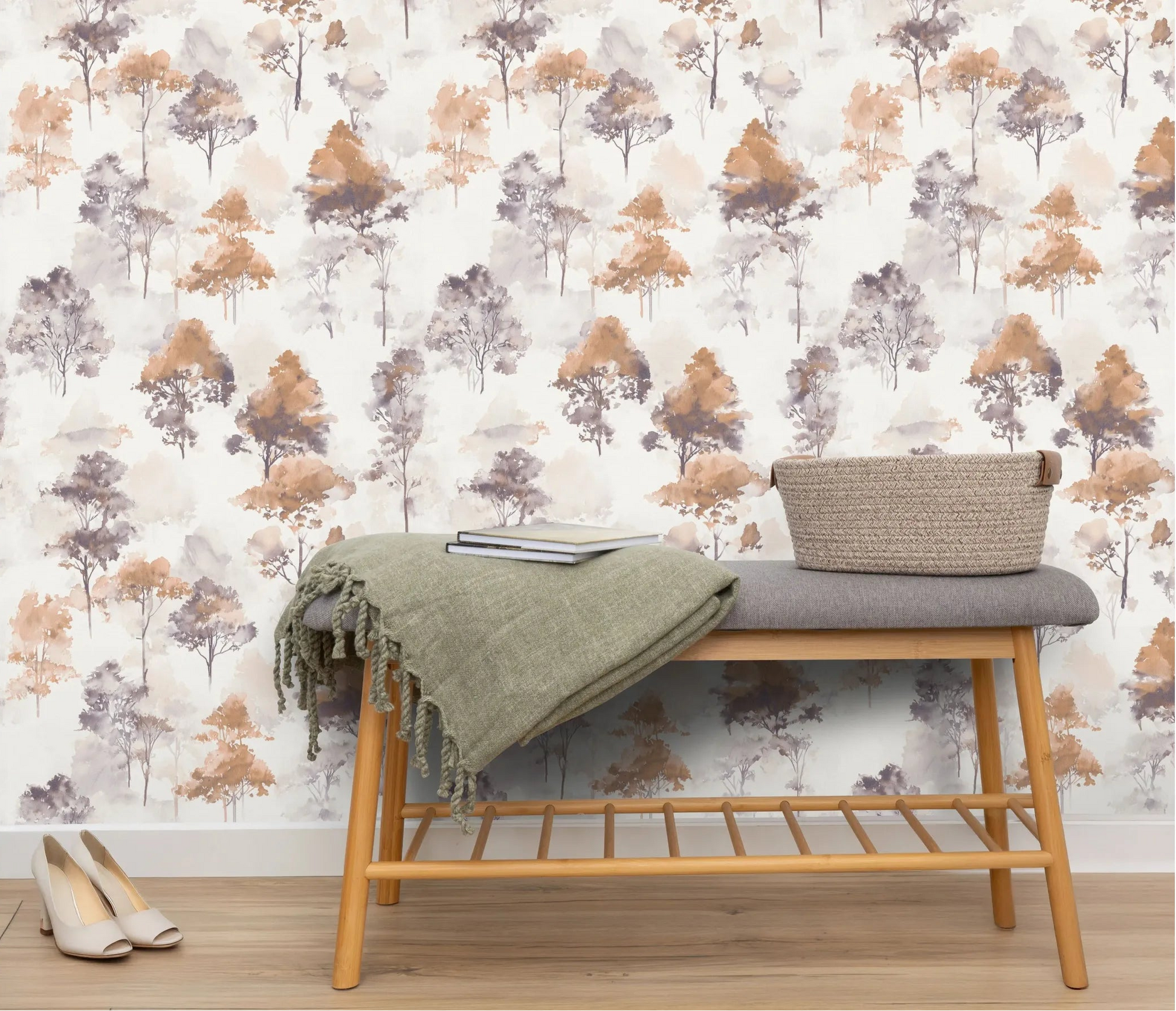 Erismann Forest Dreams 10557-11 wallpaper on the wall behind a bench with green throw, books, woven basket, and shoes.