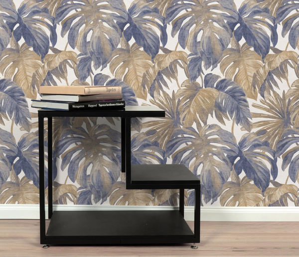 Erismann Forest Dreams 10558-44 wallpaper on a wall behind a black shelving unit topped with stacked books.