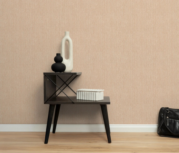 Erismann Forest Dreams 10559-04 wallpaper on a textured beige wall behind a dark side table with vases and a bag.