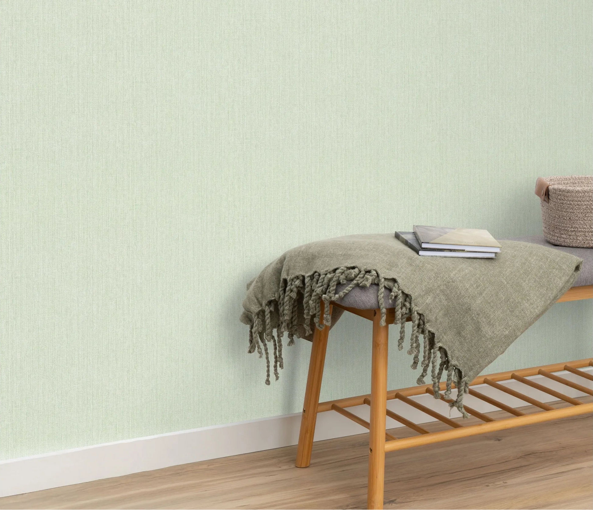 Erismann Forest Dreams 10559-07 wallpaper on the wall behind a wooden bench with fringed throw, books, and woven basket.