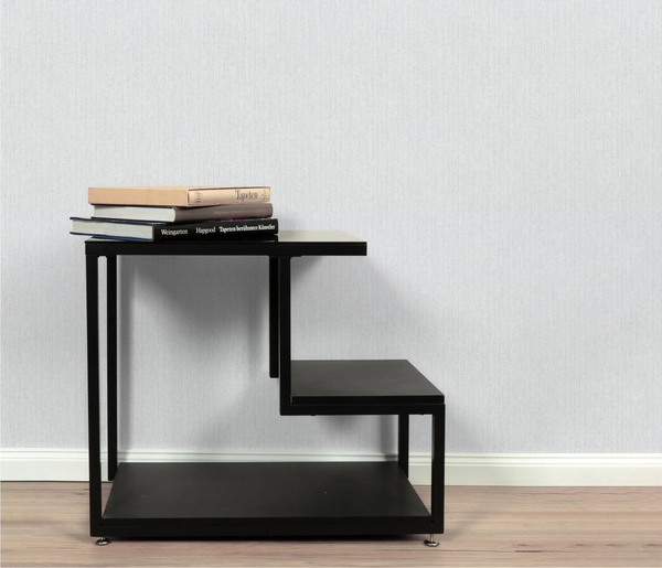 Erismann Forest Dreams 10559-10 wallpaper on a pale textured wall behind a black tiered shelf with stacked books.
