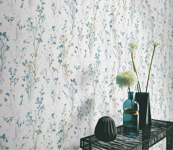 Erismann Forest Dreams 10561-18 wallpaper with delicate blue botanical stems behind a black wire console table with vases and flowers.