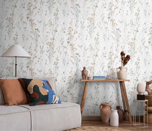 Erismann Forest Dreams 10561-35 wallpaper with delicate wildflower stems behind a sofa, floor lamp, and decorated console table.