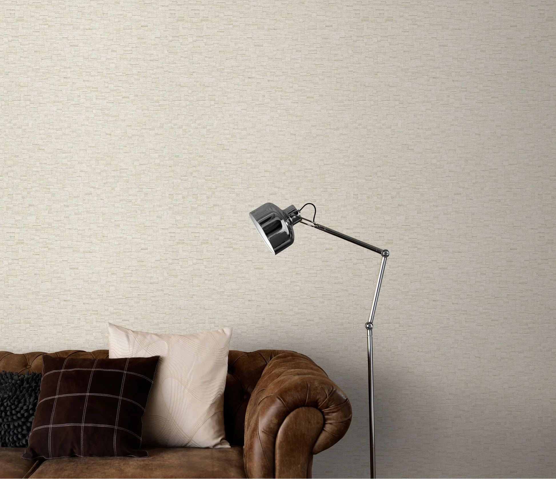 Erismann Forest Dreams 10562-02 wallpaper on a subtle textured wall behind a brown leather sofa with cushions and floor lamp.