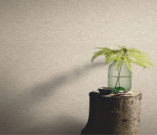 Erismann Forest Dreams 10562-32 wallpaper on a textured wall behind a tree stump table with glass vase and fern stems.
