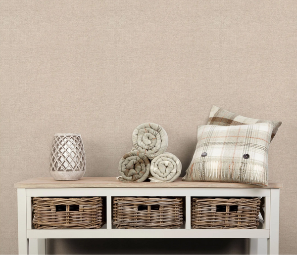 Erismann Forest Dreams 10563-02 wallpaper a neutral textured wall behind a console table with baskets, rolled blankets, a lantern, and a plaid cushion.