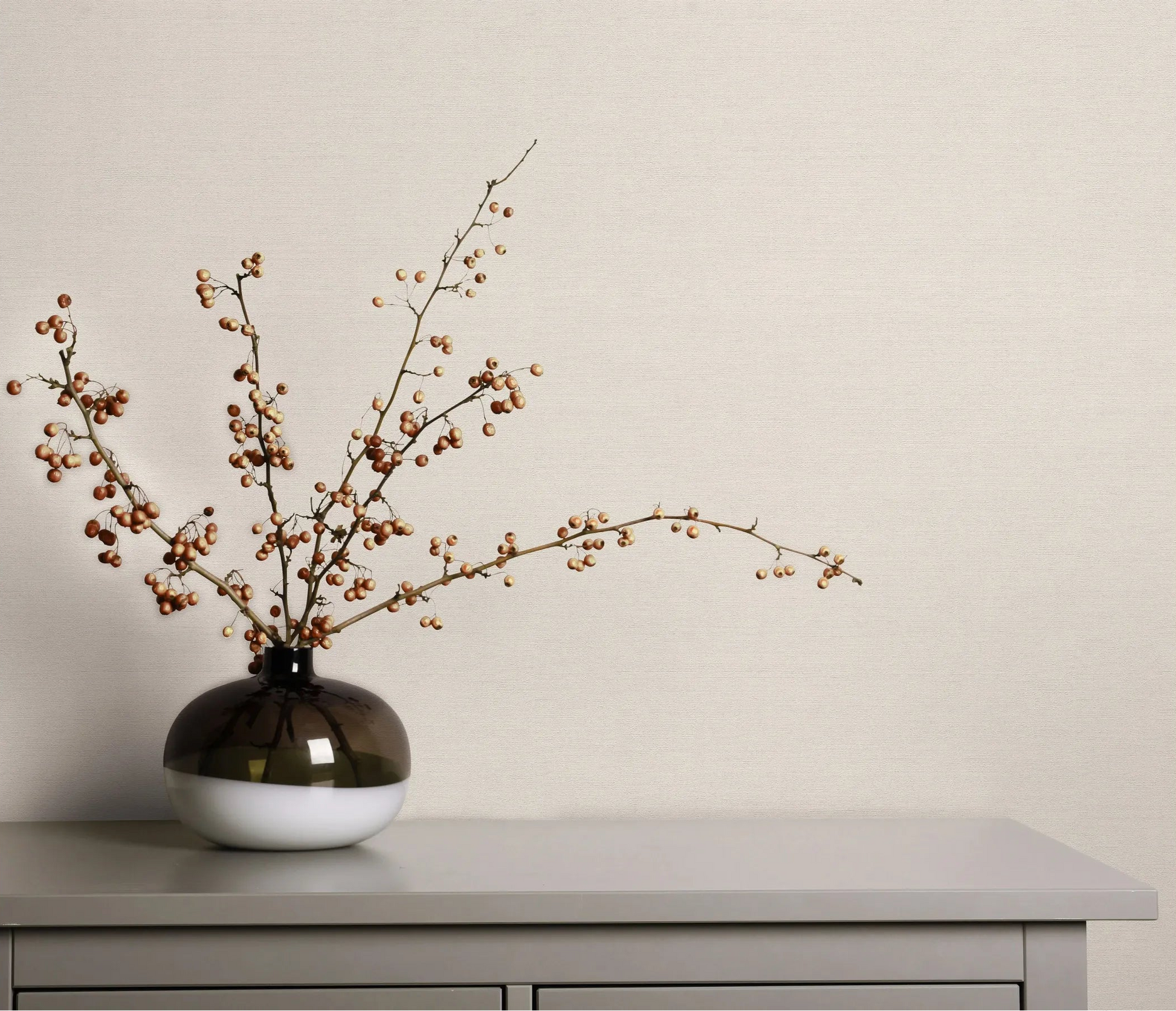 Erismann Forest Dreams 10563-26 wallpaper on the wall behind a chest of drawers with a vase of berry branches.