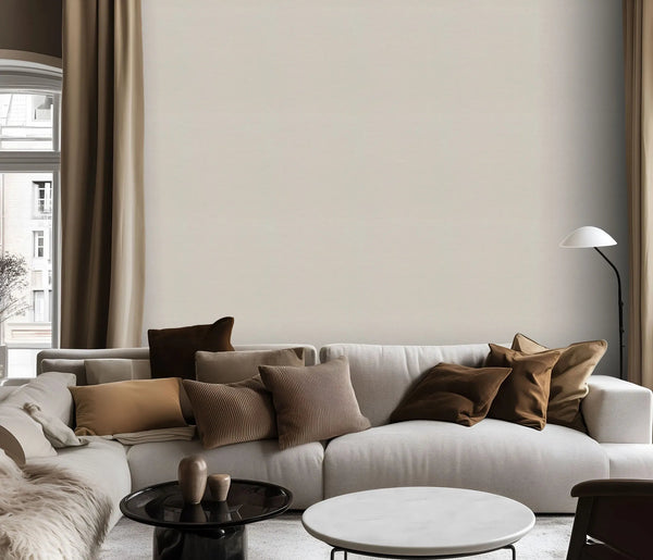 Erismann Forest Dreams 10563-26 wallpaper on a plain light wall behind a sectional sofa with cushions and floor lamp.