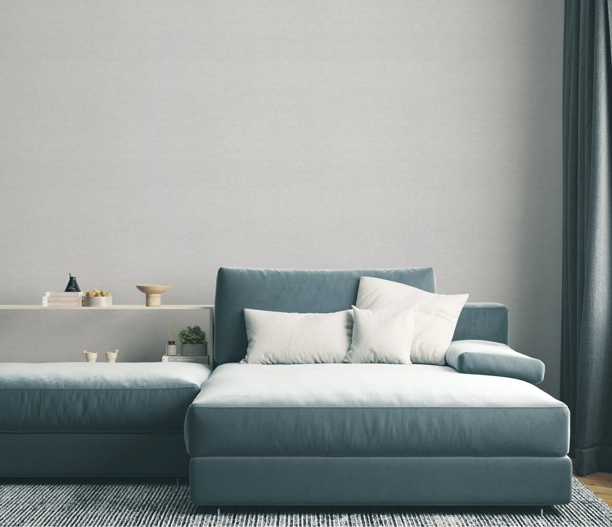 Erismann Forest Dreams 10563-31 wallpaper on a softly textured wall behind a blue sectional sofa with white cushions.