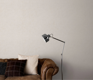 Erismann Forest Dreams 10563-38 wallpaper on a softly textured wall behind a brown sofa with cushions and floor lamp.