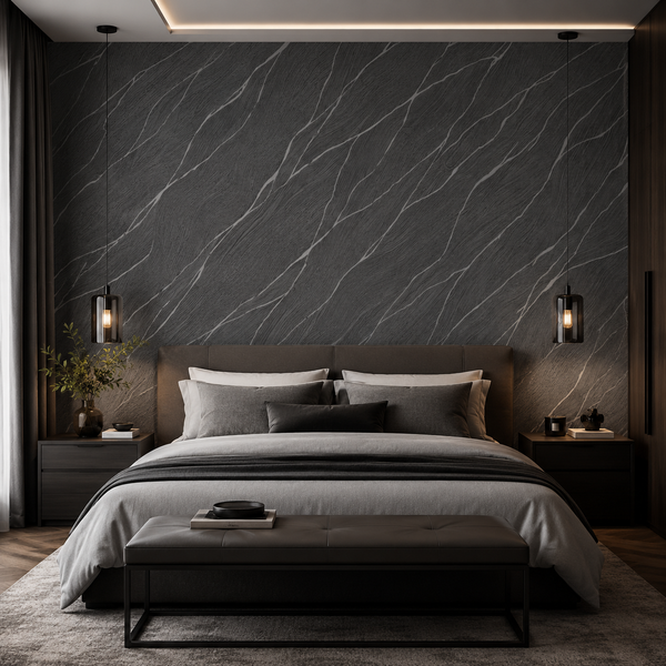 Erismann Opus 10440-15 charcoal marble-effect wallpaper behind a modern bed in a moody bedroom with black accents, grey bedding, pendant lighting, and a refined dark luxury look.