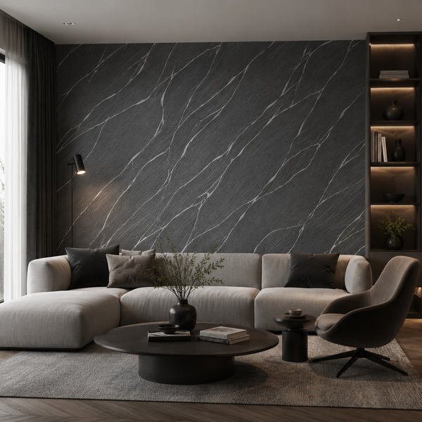 Erismann Opus 10440-15 charcoal marble-effect wallpaper on a dramatic living room feature wall with a light sectional sofa, black coffee table, dark shelving, and moody contemporary styling.