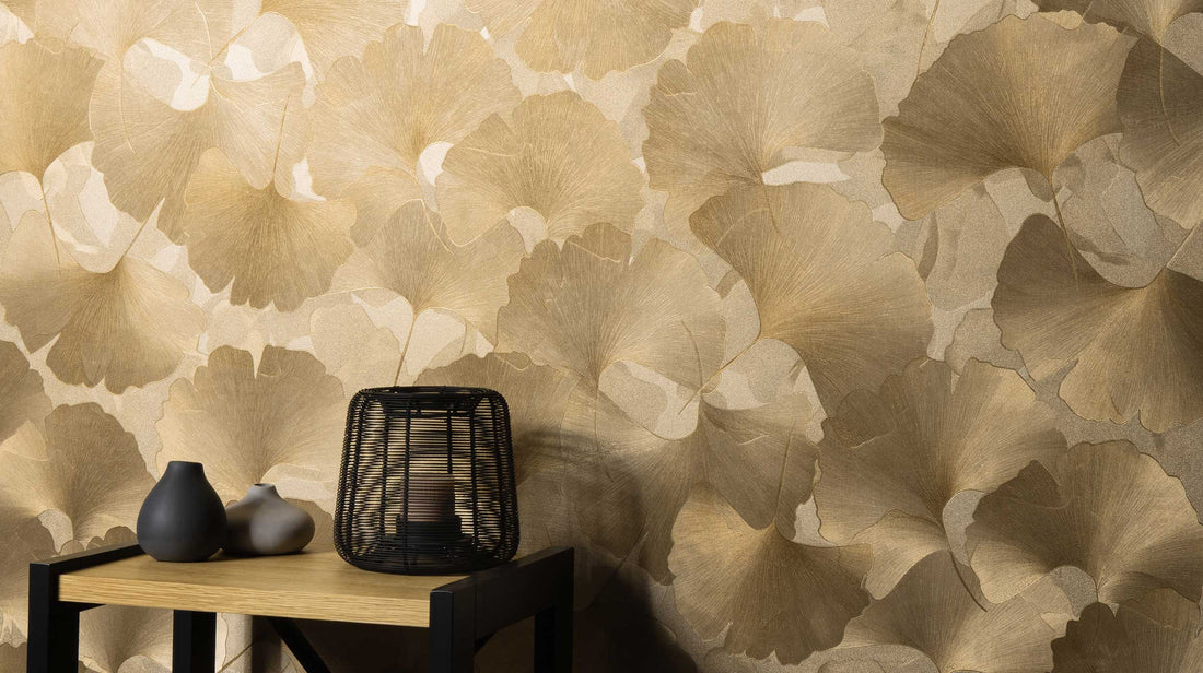 Erismann Elysium botanical wallpaper featuring subtle ginkgo leaf silhouettes in soft beige and white tones, creating a light, minimal and elegant backdrop.