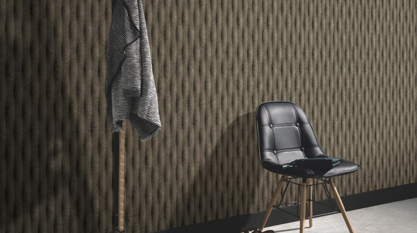 Erismann Fashion for Walls 5 textured vertical stripe wallpaper in dark brown tones styled in a modern interior with a black chair and minimalist décor.