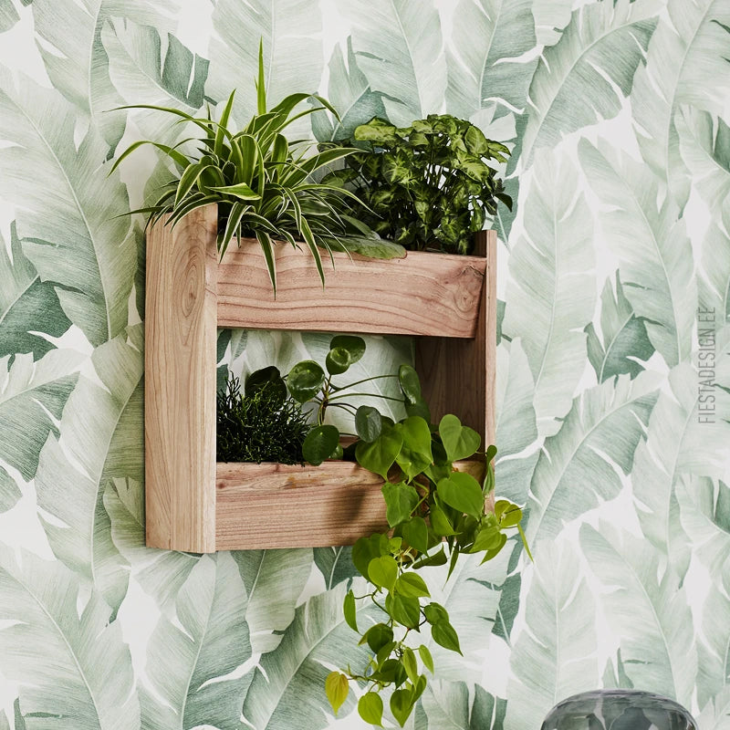 Marburg Avalon 31650 Large tropical leaf motif in soft green tones on a white background wallpaper shown in a styled detail.