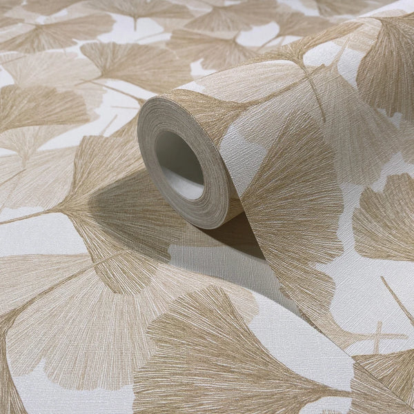 Marburg Boho 35784 Close-up of a wallpaper roll showing a beige fan-shaped leaf pattern on a white background, resting on matching unrolled wallpaper.