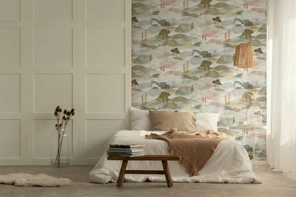 Marburg Boho 35785 Painterly landscape wallpaper featuring layered rolling hills with small trees in soft, muted tones wallpaper on a bedroom feature wall.