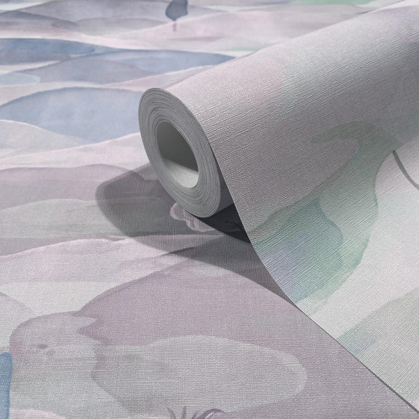 Marburg Boho 35788 Close-up of a textured wallpaper roll resting on matching unrolled sheet, showing abstract watercolor-style shapes in soft blue and green on a light ground.