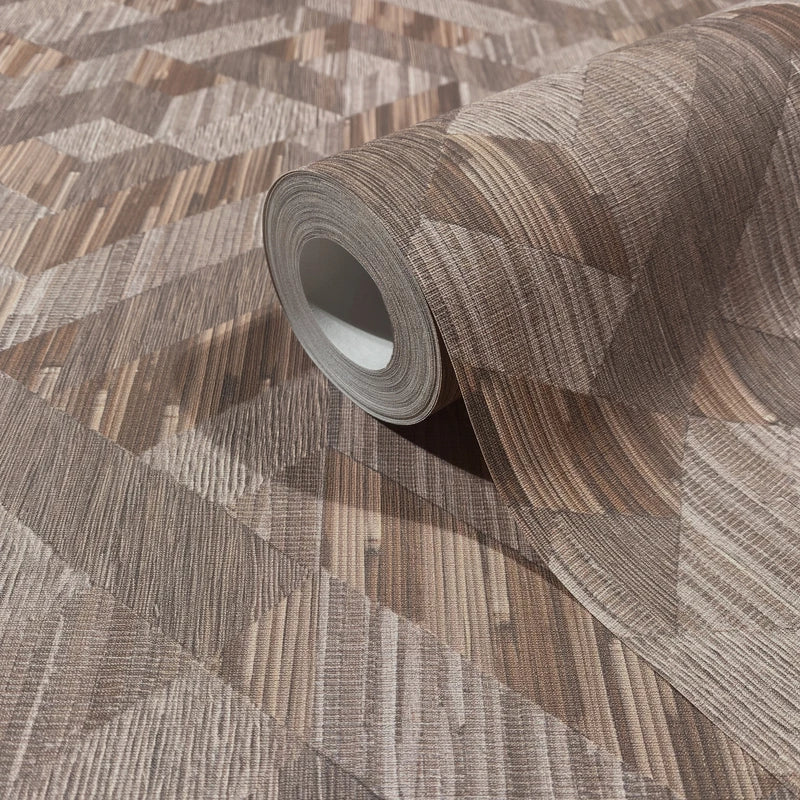 Marburg Boho 35789 Roll of brown wallpaper with a geometric woodgrain pattern, partially unrolled on matching wallpaper.