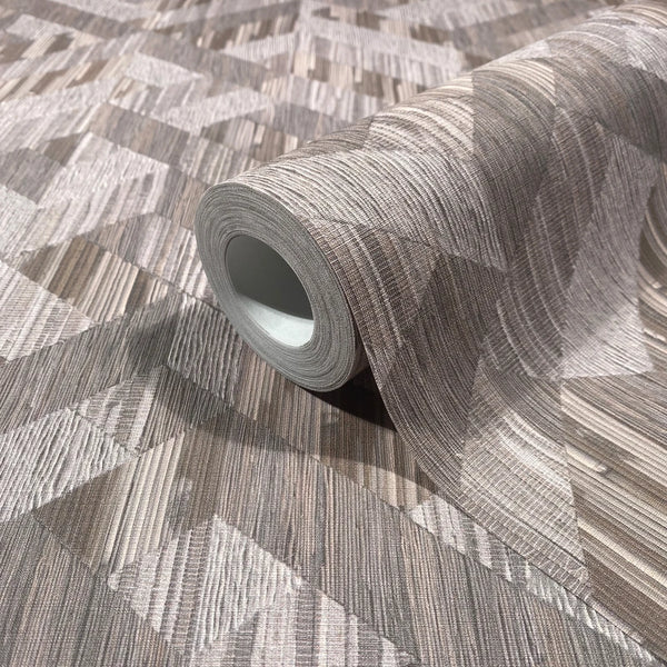 Marburg Boho 35791 A wallpaper roll resting on an unrolled sheet showing a brown and grey geometric pattern of angled blocks with fine linear striations; the roll core is visible.