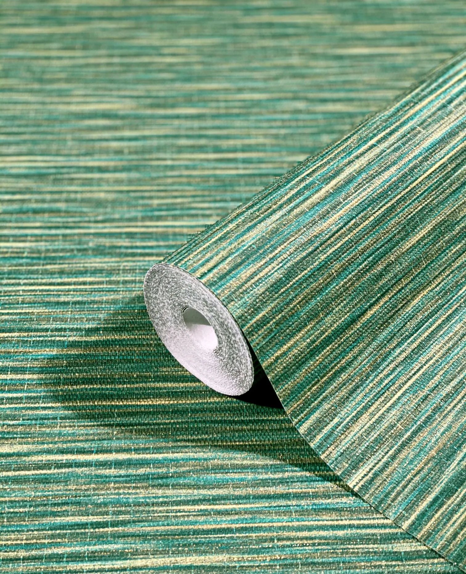 Marburg Botanica 33317 Close-up of a green horizontally striped wallpaper shown as a partially unrolled roll resting on the matching patterned surface.