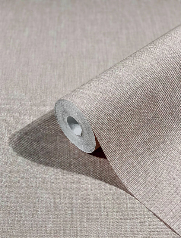 Marburg Botanica 33327 Close-up of a beige textured wallpaper roll partially unrolled on a matching surface, showing a fine crosshatch pattern and cast shadow.
