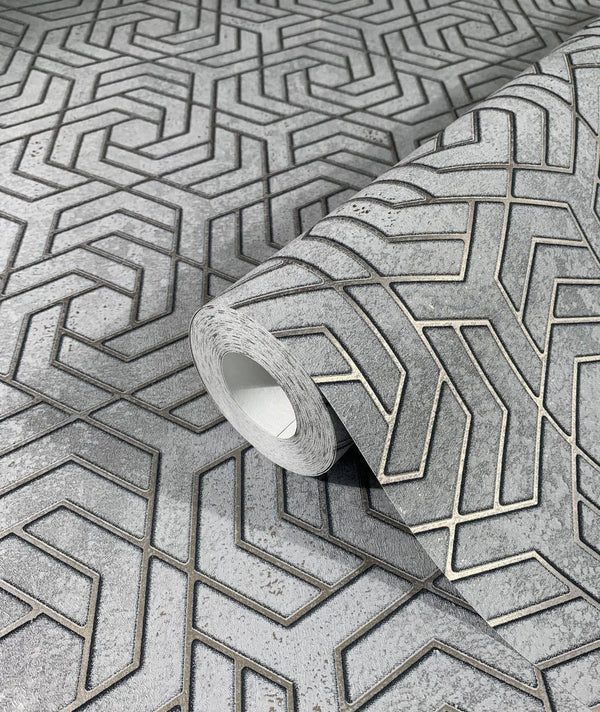 Marburg City Glam 32610 A roll of gray wallpaper on a matching surface, showing a raised interlocking chevron geometric pattern with a mottled background.