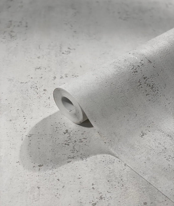 Marburg City Glam 32612 A light gray speckled wallpaper roll partially unrolled on matching material, showing the textured pattern up close.
