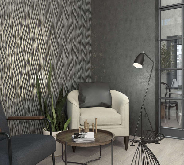 Marburg City Glam 32638 Living room corner featuring a dark grey wavy-pattern wallpaper on the left wall beside a mottled dark wall, with a cream armchair, black floor lamp, round coffee table, and a potted plant.