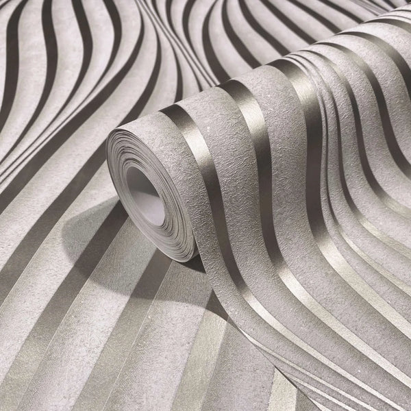Marburg City Glow 34259 Close-up of a wallpaper roll showing a textured ground with flowing metallic wavy stripes, resting on the same pattern.