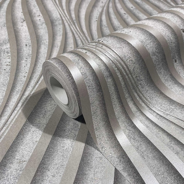 Marburg City Glow 34261 Close-up of a wallpaper roll resting on matching paper, showing a gray wavy striped design with alternating smooth and textured bands.