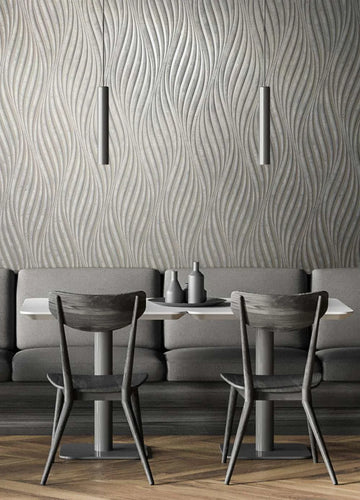 Marburg City Glow 34261 Gray wallpaper with flowing vertical wave lines behind a dining nook with a table, two chairs, banquette seating, and two slim pendant lights.