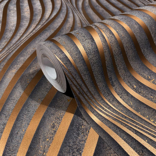 Marburg City Glow 34263 Wallpaper roll on matching surface showing wavy copper stripes across a dark textured background with speckled detail.