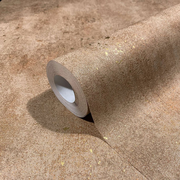 Marburg City Glow 34268 Close-up of a brown textured wallpaper roll with scattered metallic gold flecks resting on the same pattern.