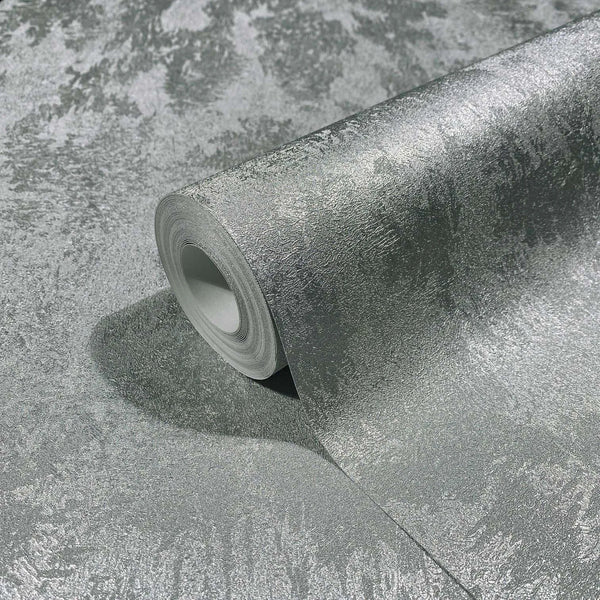 Marburg City Glow 34275 A metallic silver textured wallpaper roll partially unrolled on a matching surface, showing its irregular mottled pattern and sheen.