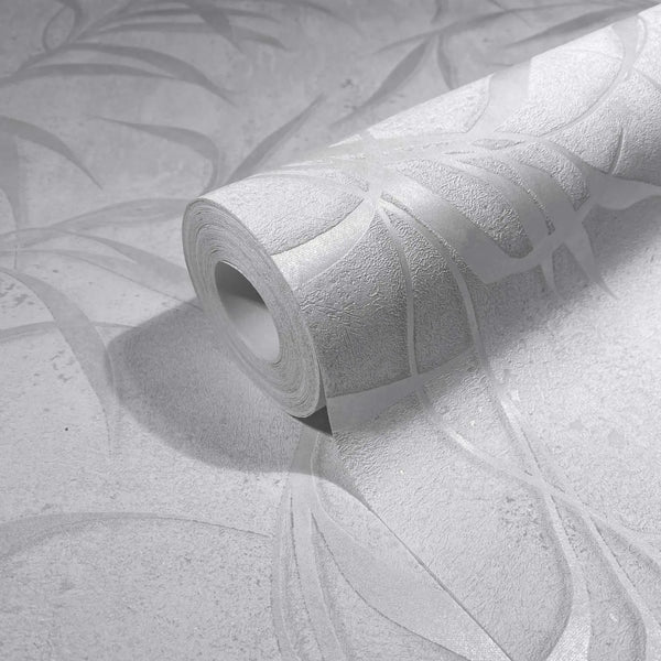 Marburg City Glow 34283 Angled wallpaper roll resting on matching light gray wallpaper, showing an abstract sweeping ribbon design with subtle texture.