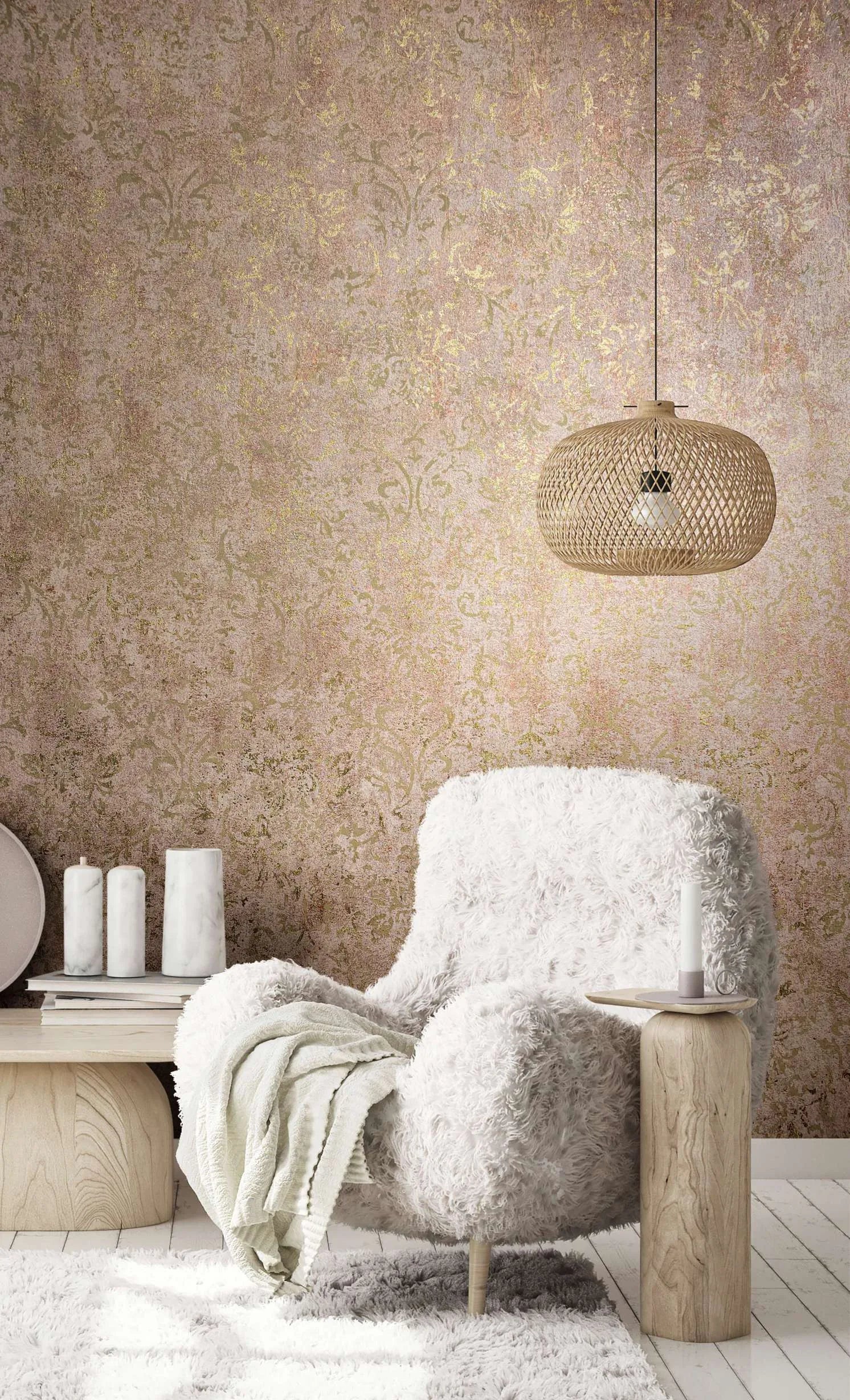 Marburg City Glow 34295 Living room vignette featuring a warm brown wallpaper with a weathered damask pattern and gold highlights. A woven rattan pendant hangs above a plush white armchair with a throw, beside a small wood side table with a candle; a low bench with books and two tall.