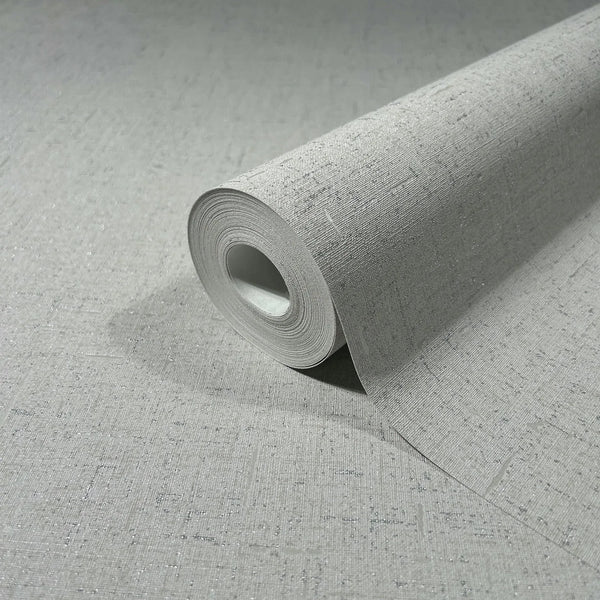Marburg City Romance 35109 Close-up of a gray textured wallpaper roll with subtle metallic speckles, shown partly unrolled on the same pattern.