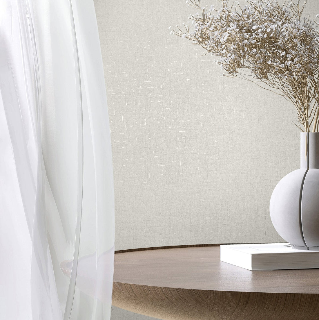 Marburg City Romance 35115 White textured wallpaper with a subtle crosshatch look behind a sheer curtain, a round wooden table, a spherical vase holding dried stems, and a closed book.