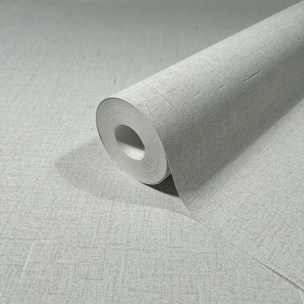 Marburg City Romance 35116 Close-up of a light gray textured wallpaper roll resting on the same pattern, showing a fine crosshatch surface.