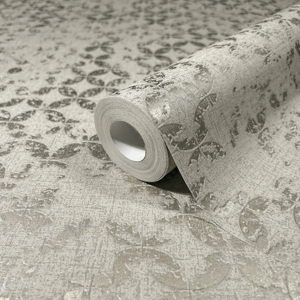 Marburg City Romance 35118 Close-up of a gray wallpaper roll on a matching surface, showing a repeating leaf-and-circle motif on a textured background.