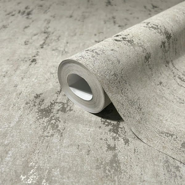 Marburg City Romance 35123 Close-up of a gray wallpaper roll with an abstract mottled texture resting on a matching unrolled section.